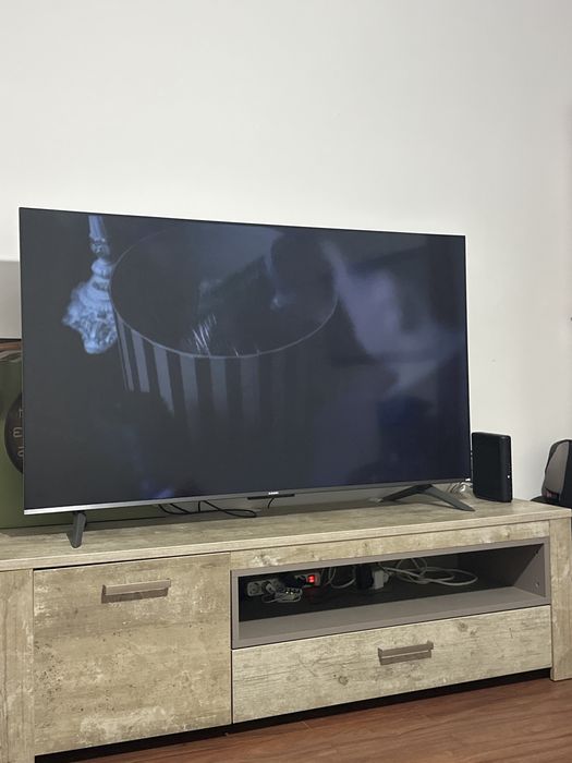 Móvel TV cor neutra com gavetas e prateleira interna.