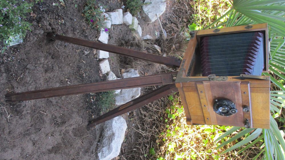 Máquina fotográfica muito antiga de madeira com fole