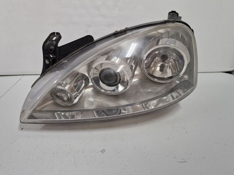 OPEL CORSA C LIFT LAMPA LEWY PRZÓD LEWA PRZEDNIA REFLEKTOR SOCZEWKA EU 13100535