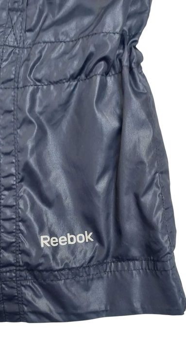 Czarna kurtka wiatrówka z chowanym kapturem REEBOK, R. S