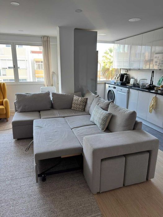 Sofá-cama cinzento de canto com chaise longue