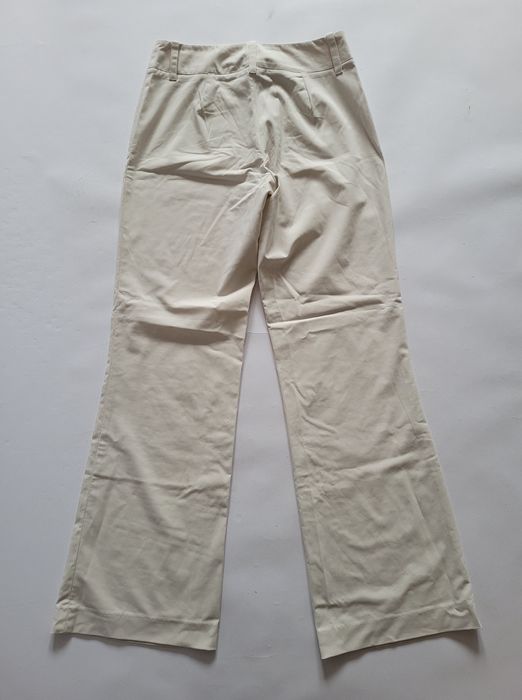 Kremowe spodnie dzwony flare bootcut niski stan biodrowki 34 XS