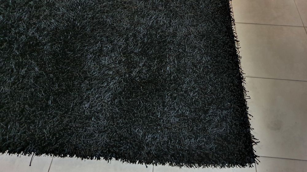 Carpete preta de pêlo longo.