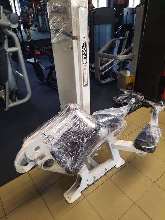 Тренажер згинання ніг лежачи