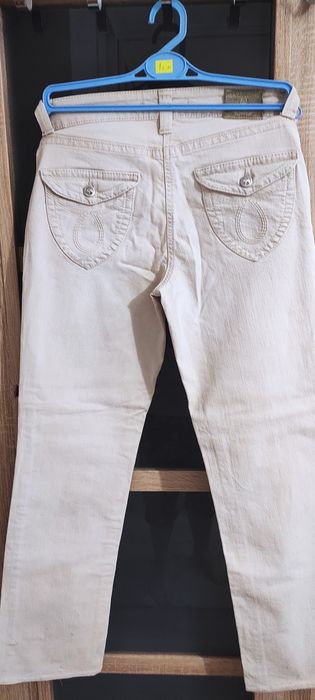 Beżowe spodnie z cyrkoniami 38