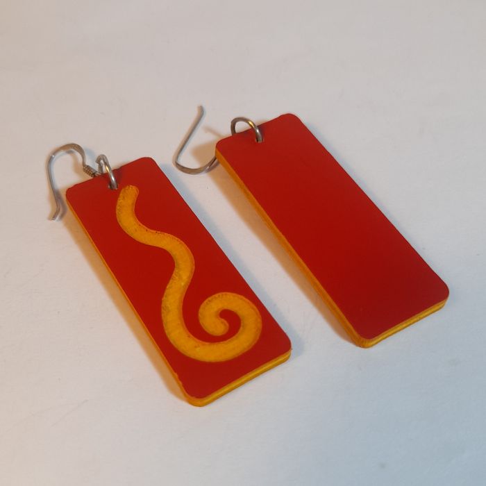 Wooden earrings in the shape of spirals.