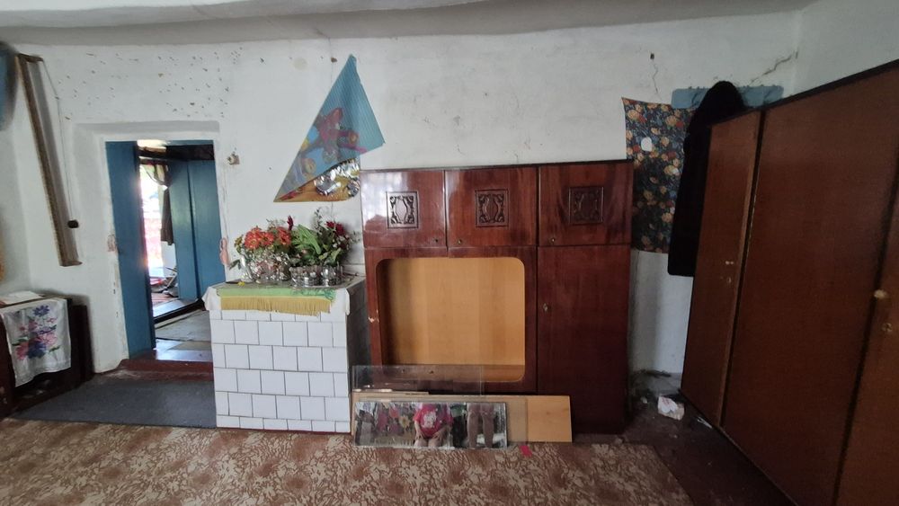 Будинок з джерельною водою на березі річки, асфальтована дорога