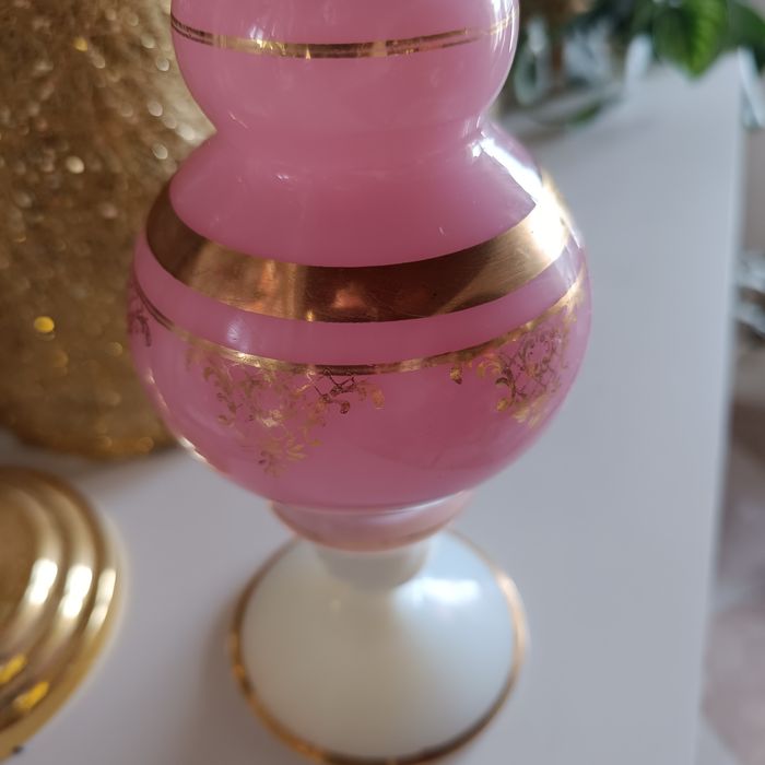 Uma imponente jarra rosa opalescente, com sua abertura rendada