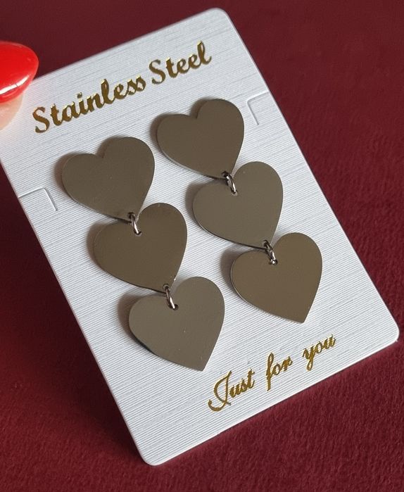 Silver earrings made of steel, with 3 hearts aligned in a row. With a hook.