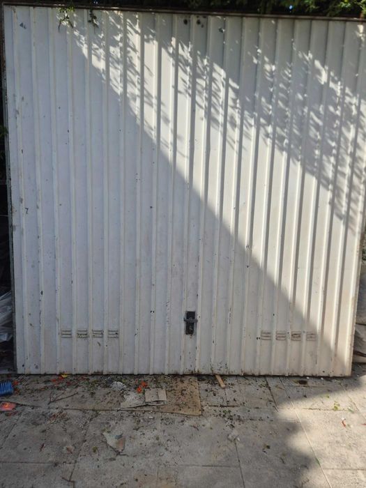 Portão em chapa basculante a funcionar com fechadura.