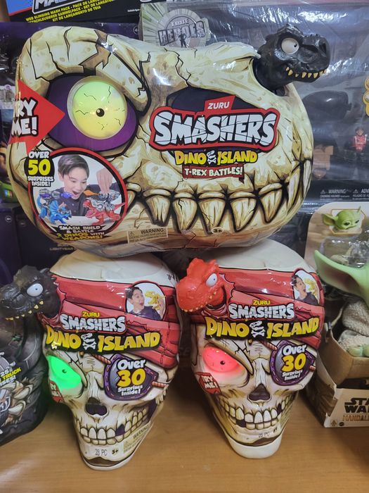 Динозавр Трекс в черепе с песком и 30 сюрпризов Smashers Dino Island