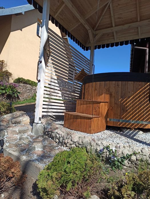 Dom nad jeziorem z jacuzzi ogrodowym .