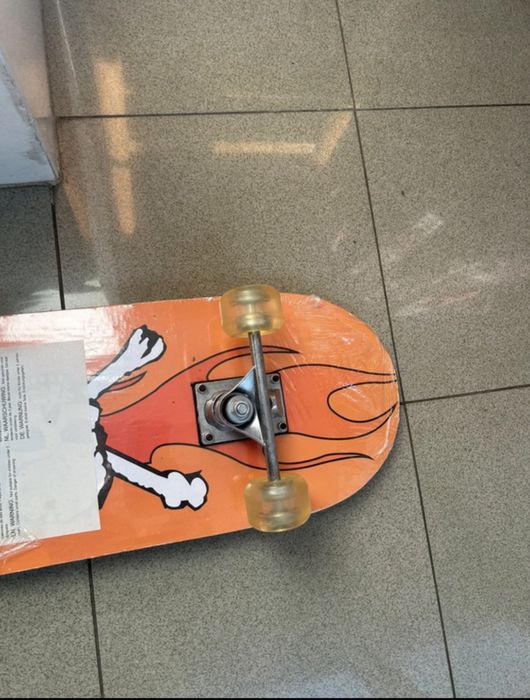 Black skatebroad with orange graphic