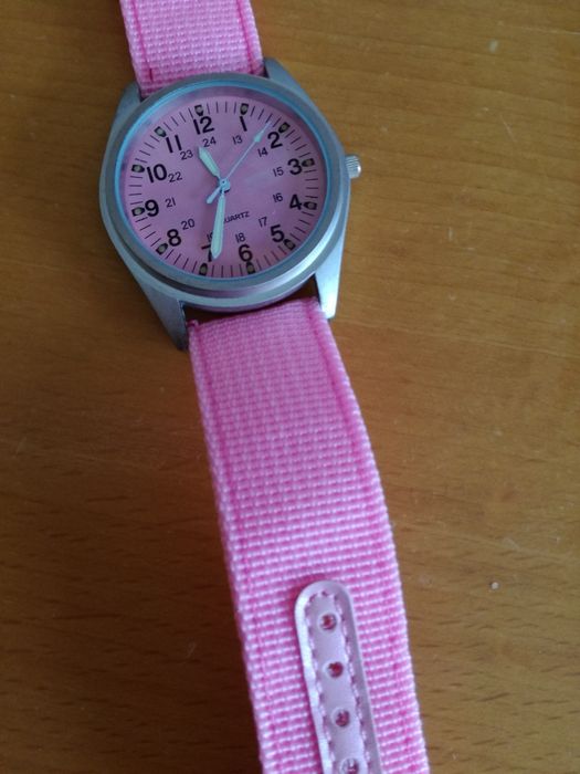 Pink aviator-style watch with luminous hands