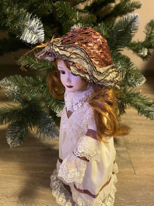 Фарфорова лялька зі змінними капелюшками.