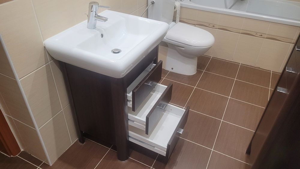 Cersanit, słupek, szafka z umywalką oraz bateria łazienkowa.