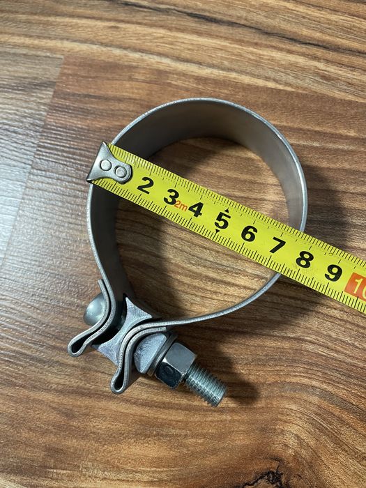 Новый алюминиевый хомут 75-80 мм.