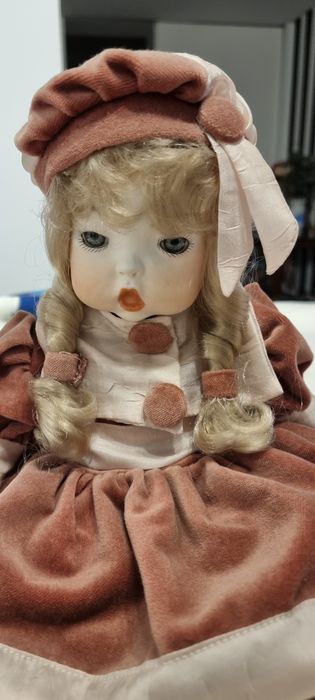 Boneca antiga em porcelana e vestido de veludo rosa