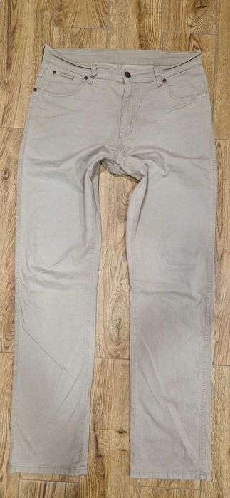 Beżowe Spodnie męskie jeans Wrangler Texas Stretch W34L34