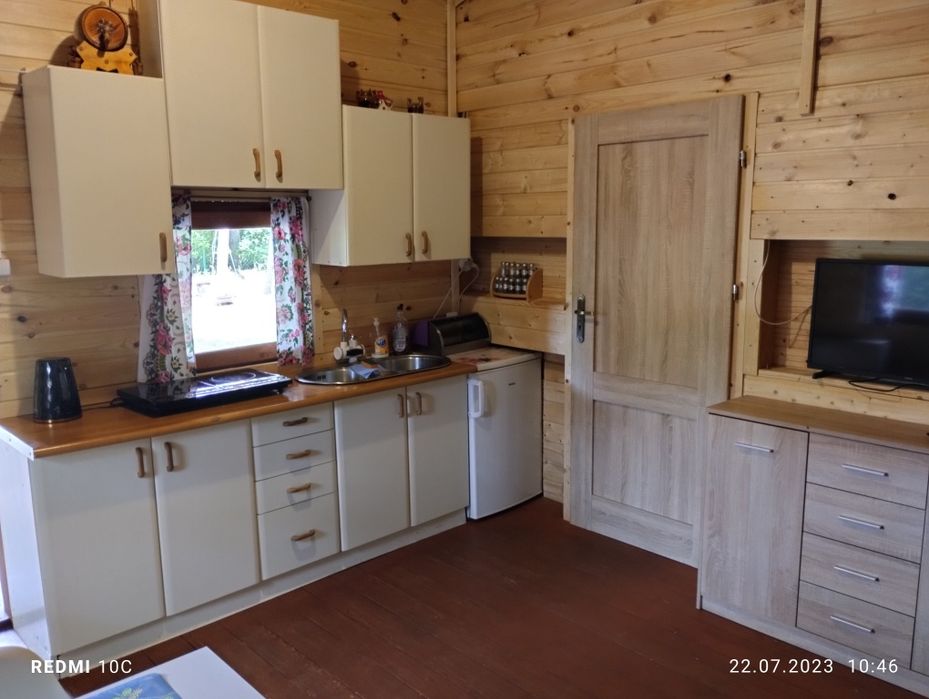 Domek nad zalewem na ogrodzonej działce.