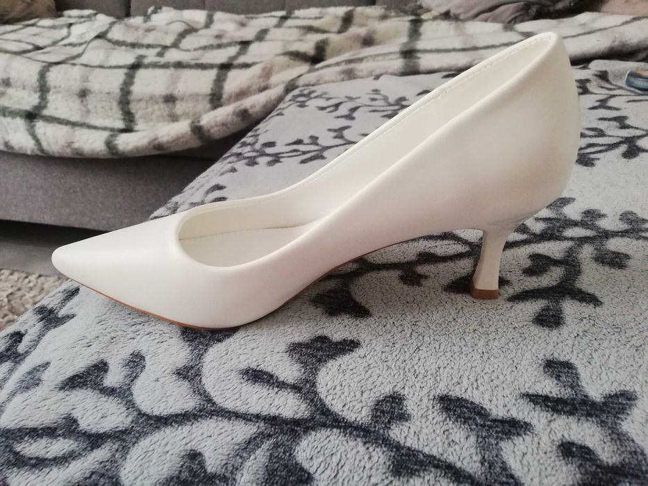 Białe szpilki damskie.