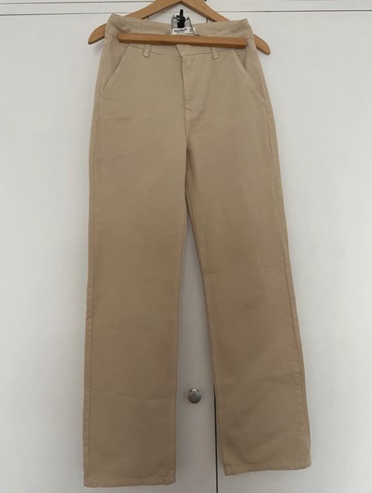 Calças de ganga bege com bolsos laterais