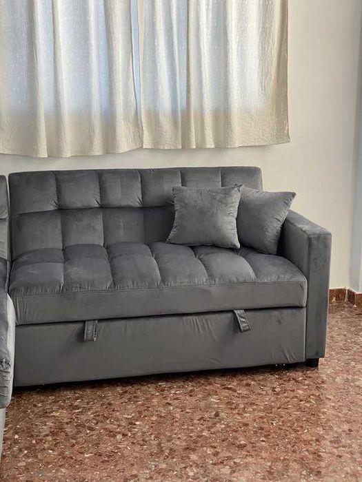 sofá-cama cinzento de veludo com espaço de arrumação