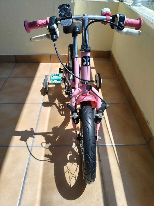 Bicicleta infantil rosa com rodinhas de apoio