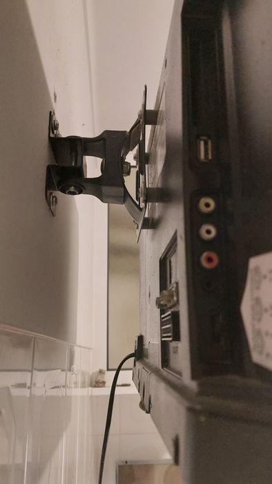 Televisão com suporte de parede e comando