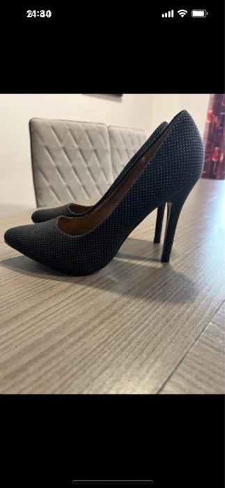Sapatos de salto alto pretos com padrão brilhante dourado.