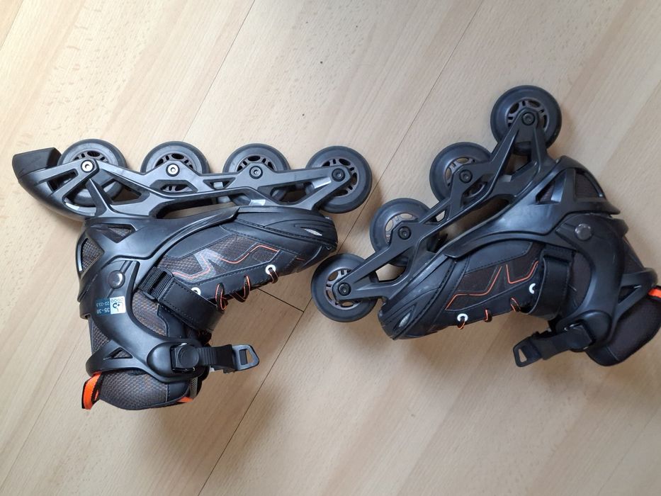 Patins em linha pretos e laranja da Olexo