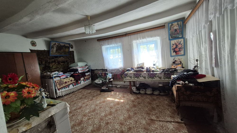 Будинок з джерельною водою на березі річки, асфальтована дорога