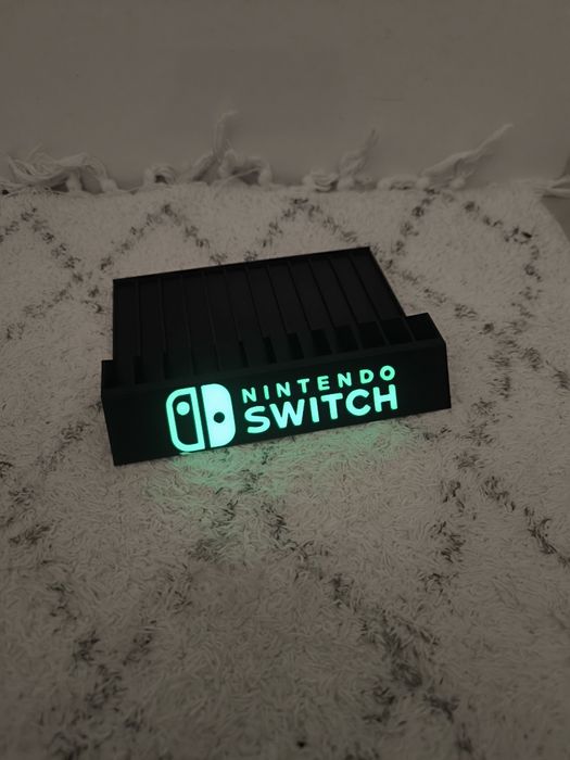 Stojak podstawka na gry Nintendo Switch napis fluorescencyjny