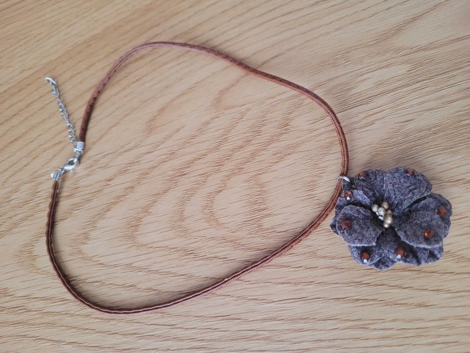Naszyjnik z brązowym kwiatkiem.