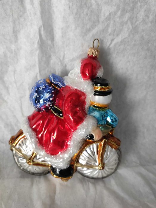 Szklana bombka Huras Family Mikołaj z bałwanem na rowerze