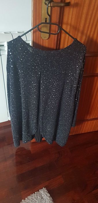 Tunica preta de malha de seda com elastano e brilhantes.