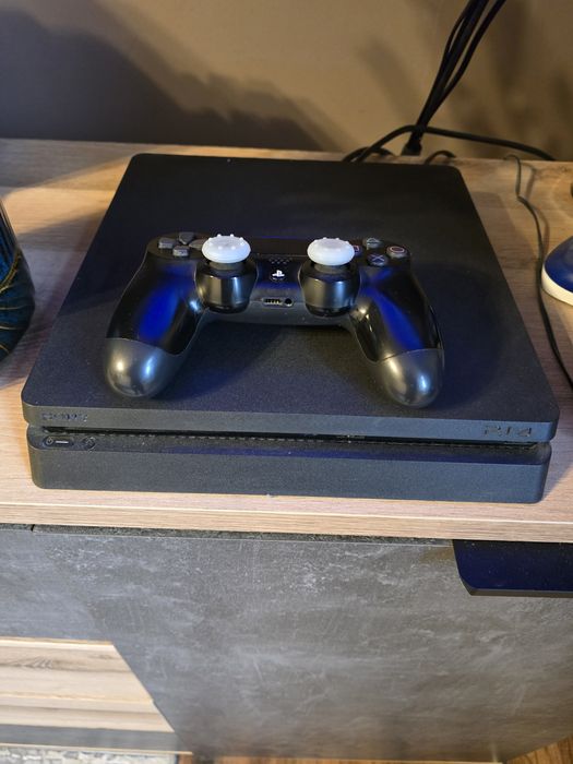 PlayStation 4 Slim 1TB z pudełkiem i grami.