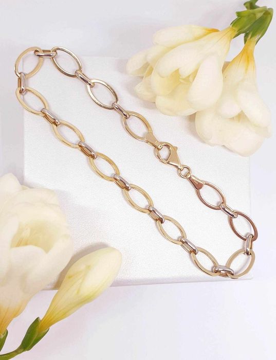 Złota bransoletka z elementami z białego złota