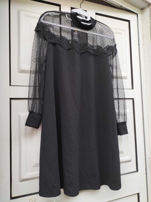 Vestido preto rendado nos ombros, parte superior do peito e mangas