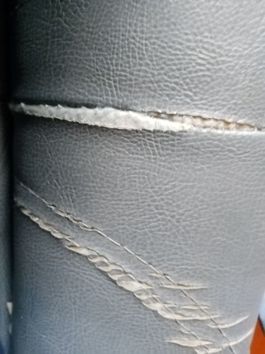 Sofá em pele sintética cor azul petróleo usado um pouco danificado