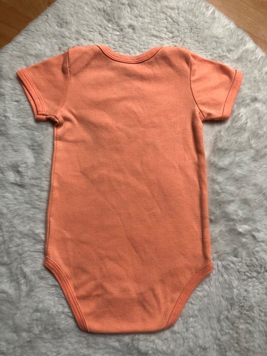 Pomarańczowe, bawełniane body z krótkim rękawem Baby