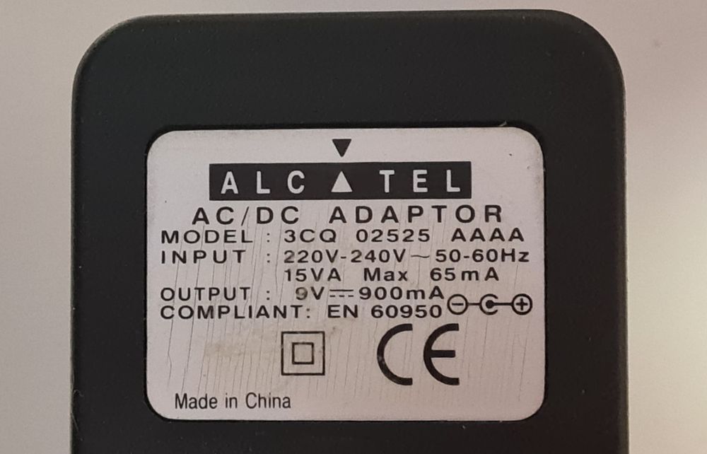 Zasilacz AC / DC 9V 900mA Alcatel  plus w środku