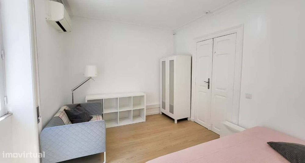 Superior room with shared bathroom and a sofa