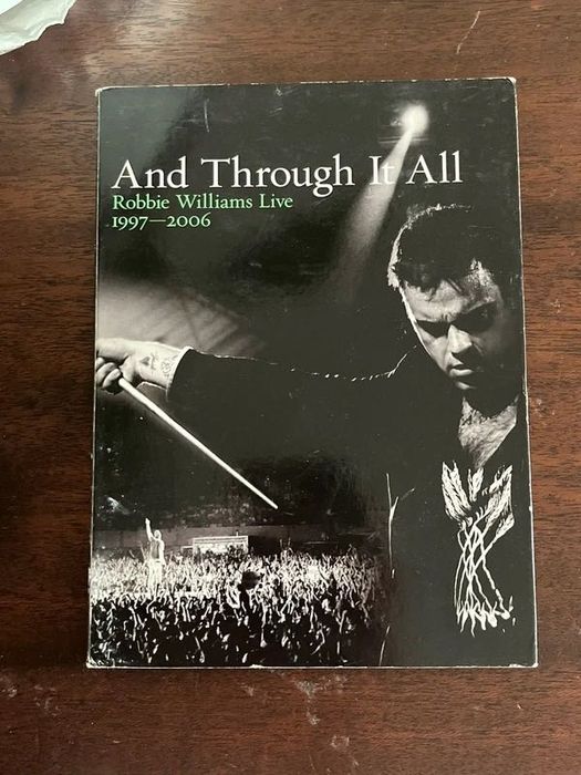 Capa original do DVD “And Through It All Robbie Williams Live 1997 - 2006