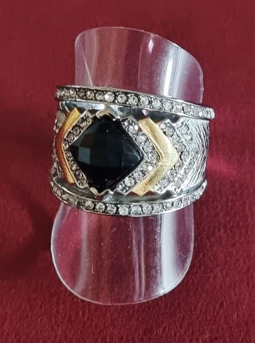Anel prateado, em aço, com zirconias e uma pedra preta lapidada. T19