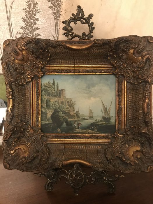 Prateleira e quadro com tela e moldura dourada trabalhada