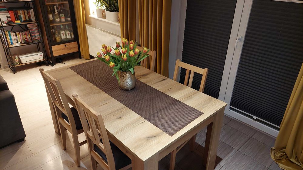 Stół z krzesłami w kolorze dębu.
