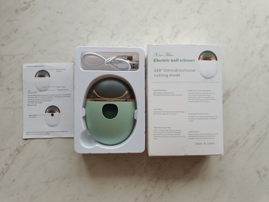 Электрическая машинка для стрижки ногтей.