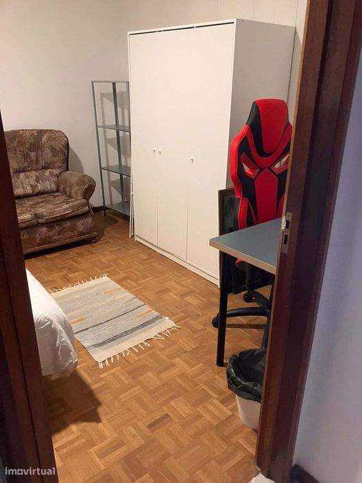 Spacious bedroom with a double bed, a desk and a couch