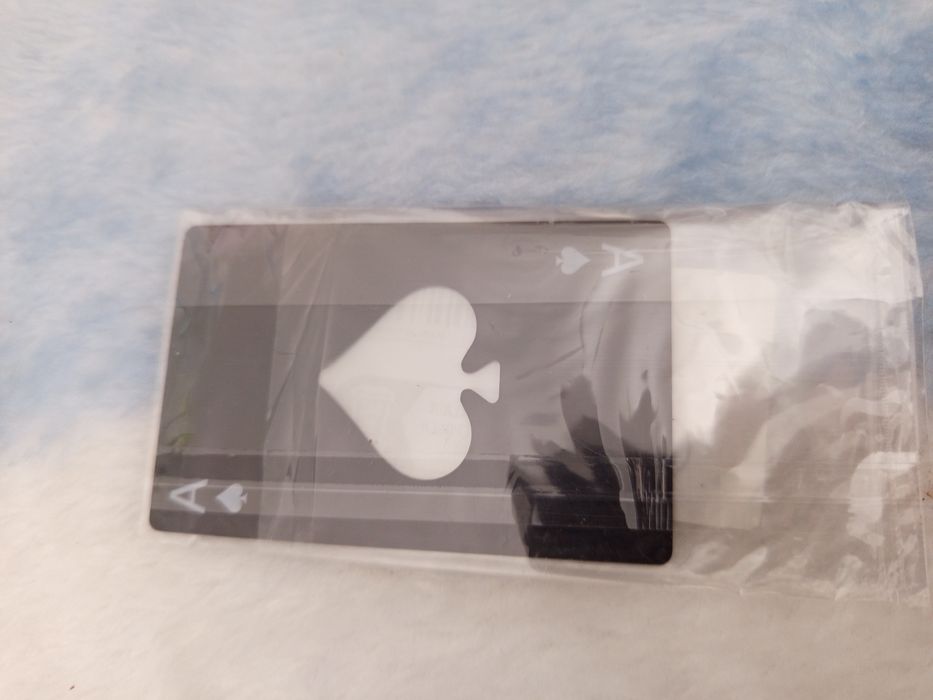 Abre cápsulas Às de paus.